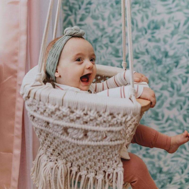 Handmade organic cotton macrame baby swing for boho nurseries